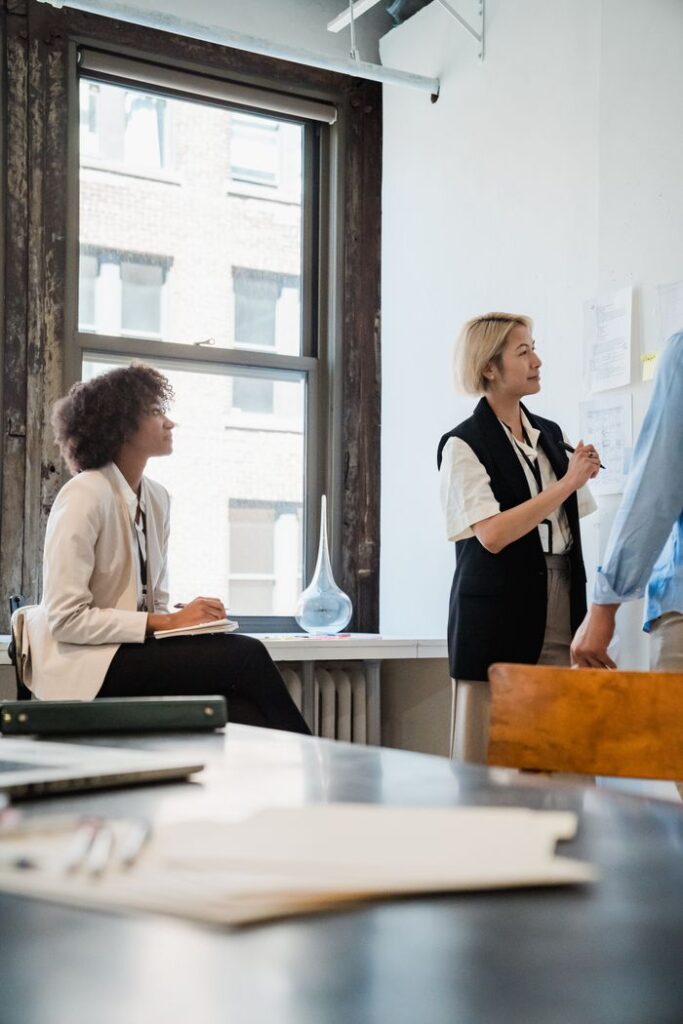 Professional team collaborating on a project in a well-lit office space.